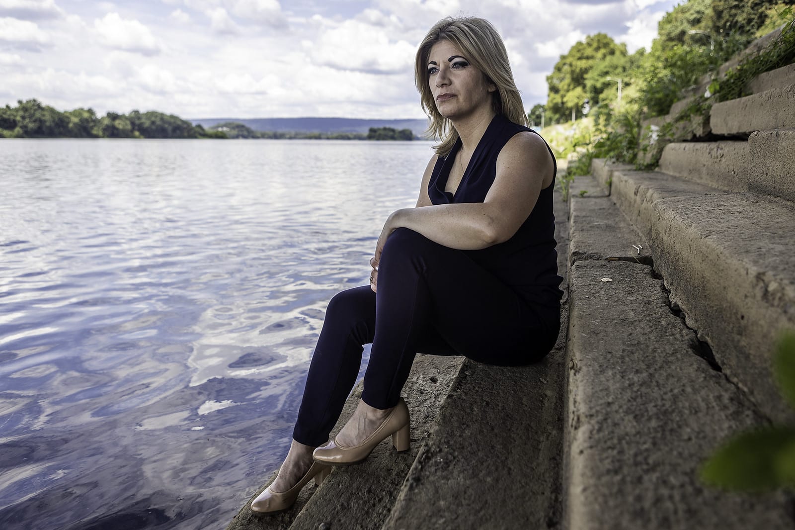 Senator Katie Muth Sits on Bank of Susquehanna River in the Chesapeak Bay watershed